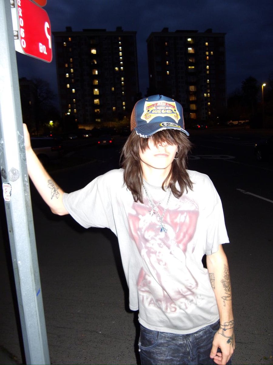 Clothing items laid out on asphalt