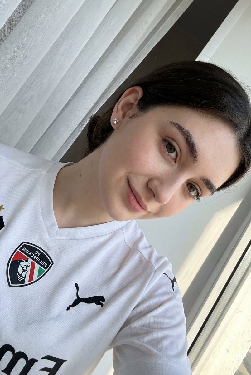 Detailed JSON prompt for a casual portrait of a young woman in a sports jersey